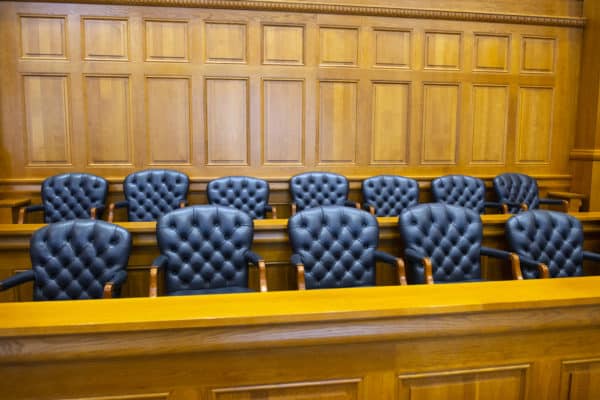 An empty juror section of a courtroom illustrating what happens if you miss jury duty in california
