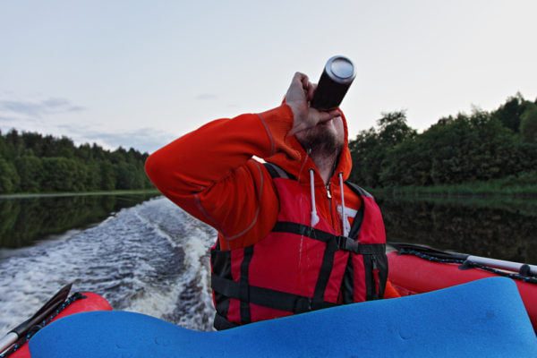 A man drinking on his boat illustrates san diego boating DUI