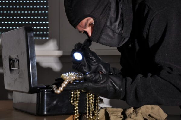 A robber going through a jewelry box