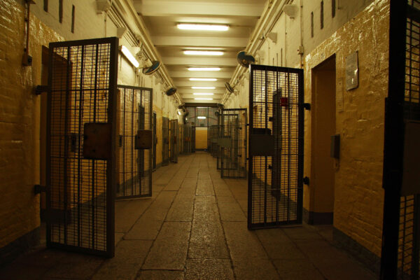 Open doors in a prison hallway
