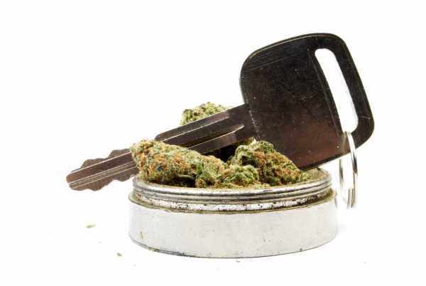 A vehicle key in a small jar of marijuana to illustrate DUID charges in Vista