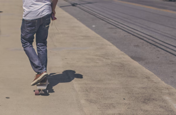 A skateboarder on the sidewalk who potentially could be charged with DUI